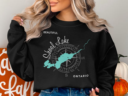 Black sweatshirt with "Beautiful Shoal Lake Ontario" text and compass graphic.