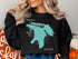 Black sweatshirt with turquoise outline map of Lake Huron and compass rose.