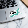 Jackson Life sticker on a laptop with a teal abstract shape and copyright text.
