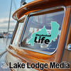 Teal outline sticker of Mendenhall Life on a boat window with "Lake Lodge Media" logo.