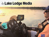 Man in boat at sunrise with Lowrance fish finder and "Lake Lodge Media" text.