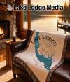Woven throw blanket on leather couch with Lake Marion, South Carolina map and compass.