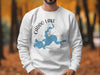 White sweatshirt with Caddo Lake map and compass graphic, labeled Texas.