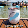 White insulated wine tumbler with Sand Lake Ontario design sitting on a wooden boat deck.
