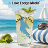 Glass with "Wefound Lake" and New Hampshire map, beach background.