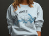 Light blue sweatshirt with Lake James, North Carolina map and compass graphic.
