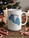 White mug with blue Lake Almanor California map graphic and holiday decor.