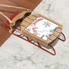 Red metal sled ornament with wooden frame featuring "Merry Christmas from Lake Francis".