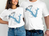 White t-shirts feature a blue map of Lake Fork, Texas with compass rose.