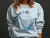 Light blue sweatshirt with Castaic Lake California graphic and compass rose.