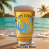 Glass of beer with Carters Lake map design on a sunny beach.