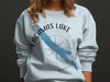 Light blue crewneck sweatshirt with Lacamas Lake map and compass design.