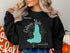 Black sweatshirt with "Beautiful Calcasieu Lake Louisiana" text and map outline.