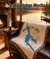 Throw blanket with Hebgen Lake Montana map design and compass rose.
