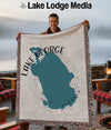 Woven blanket featuring a teal outline of Florida and text "Lake George".
