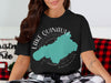 Black t-shirt with turquoise Lake Quinault outline and compass graphic.