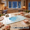 A glass cutting board featuring a blue map of Big Sandy Lake, Minnesota, rests on a granite kitchen counter surrounded by holiday baking items.