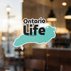 Ontario Life sticker in the shape of Ontario, on a window.