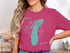 Pink t-shirt with "Lake Michigan" and compass graphic in teal.