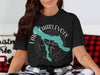 Black t-shirt with a teal map of Lake Charlevoix and a compass.