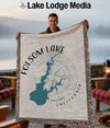 Man holding a Folsom Lake California map blanket with a compass design.