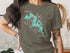 Green t-shirt with teal outline map of Evergreen Lake, Illinois.