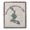 Woven throw blanket with Mooselookmeguntic Lake map design and compass rose.