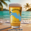 Glass of beer on a beach with Lake Wawasee map and "Lake Lodge Media" logo.