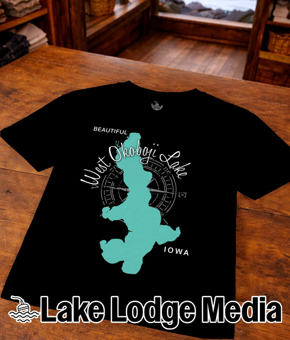 Black t-shirt featuring teal West Okoboji Lake, Iowa map silhouette and "Lake Lodge Media".