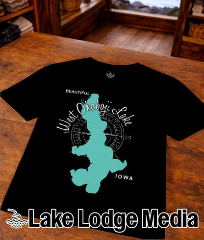 Black t-shirt featuring teal West Okoboji Lake, Iowa map silhouette and "Lake Lodge Media".