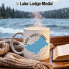 White mug with "Lake Mascuppic New Hampshire" design next to a book and scarf.