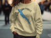 Light yellow sweatshirt with Lake San Pablo map and compass graphic in blue and gray.