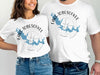 Two people wearing white t-shirts with "Lake Tobesofkee Georgia" and a blue lake map design.