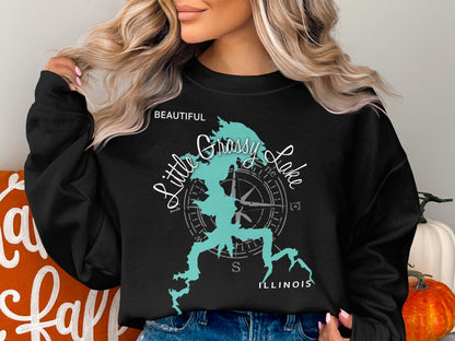 Black sweatshirt with "Beautiful Grassy Lake Illinois" and compass graphic.