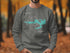 Grey sweatshirt with "Beautiful Lake Spivey Georgia" map and compass graphic.