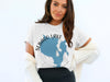 White t-shirt with Sebago Lake Maine map graphic and compass rose detail.
