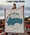Man holds Walden Pond Massachusetts map blanket with compass and text.