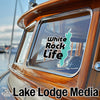 Sticker with teal outline of White Rock, Canada on boat window, with "Lake Lodge Media" text.