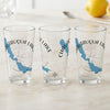 Three clear glasses with blue Chautauqua Lake map and compass design.