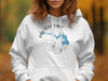White hoodie with "Pactola Lake South Dakota" text and blue lake map graphic.