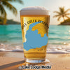 Glass of beer with "Grill Creek" text and Michigan outline on a beach.