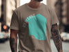 Taupe t-shirt with turquoise Red Lake Minnesota graphic and arm tattoos.