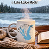White mug with Calaveras Lake map and compass graphic, steaming by a window.