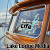 Shuswap Life sticker on a boat window with Lake Lodge Media logo below.