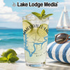 Glass with drink, lime, mint, sunglasses, and beach background.
