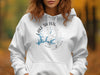 White hoodie with Lake Shasta California compass graphic and map outline.