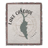 Woven blanket with Lake Cascade Idaho map silhouette and compass rose design.
