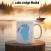 White mug with Lake Tahoe map and compass design, steam rising.