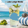 Glass with drink and lime on a beach with sailboat in background.