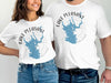 White t-shirts with "Lake Pleasant Arizona" map graphic and compass rose.